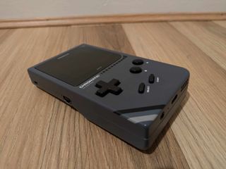 Modretro Chromatic review; a Game Boy like retro console on a wooden floor