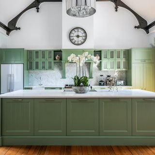 Green kitchen with glass cabinet doors