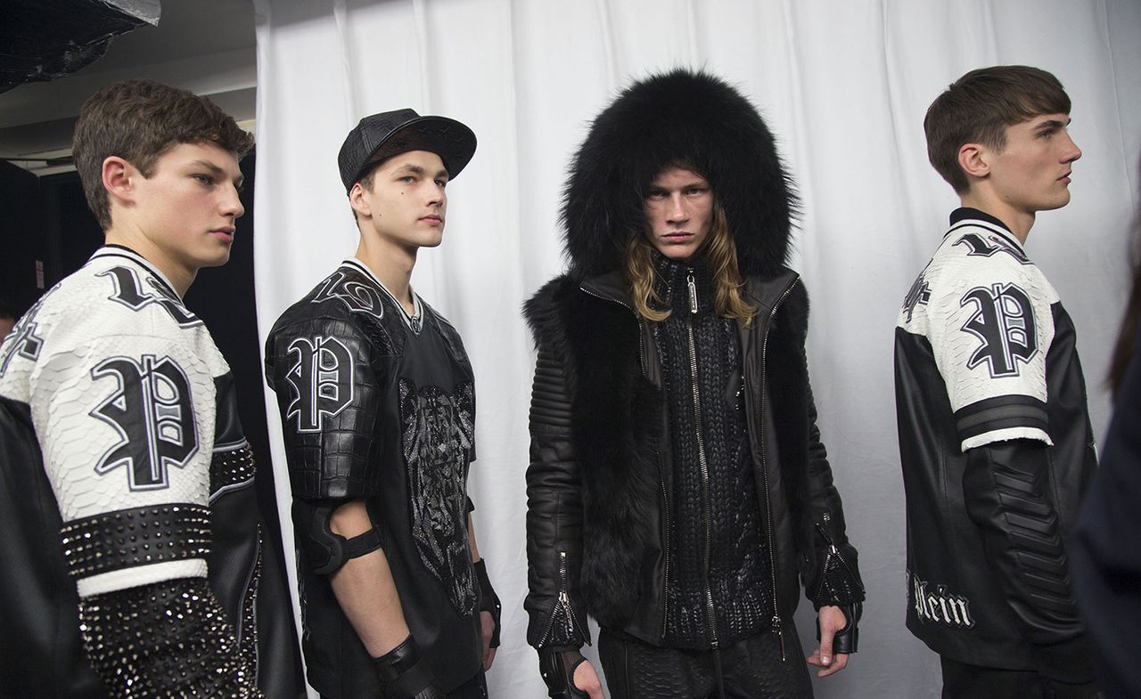 4 guys in monochrome Phillip Plein outfits at Fashion Week