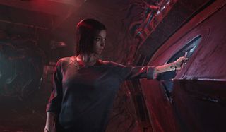 Alita: Battle Angel Alita prepares to open a door on an old ship