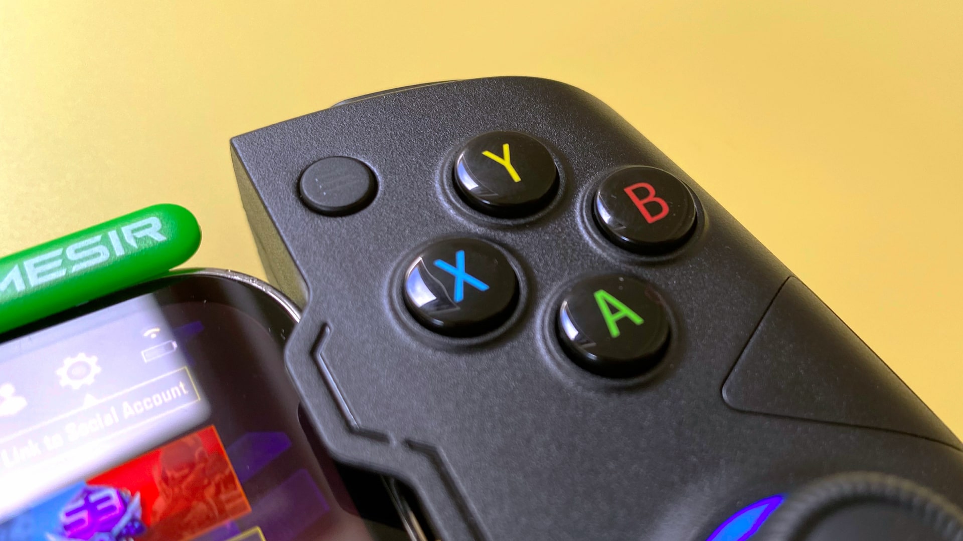 The GameSir X4 Aileron iOS games controller against a yellow background.