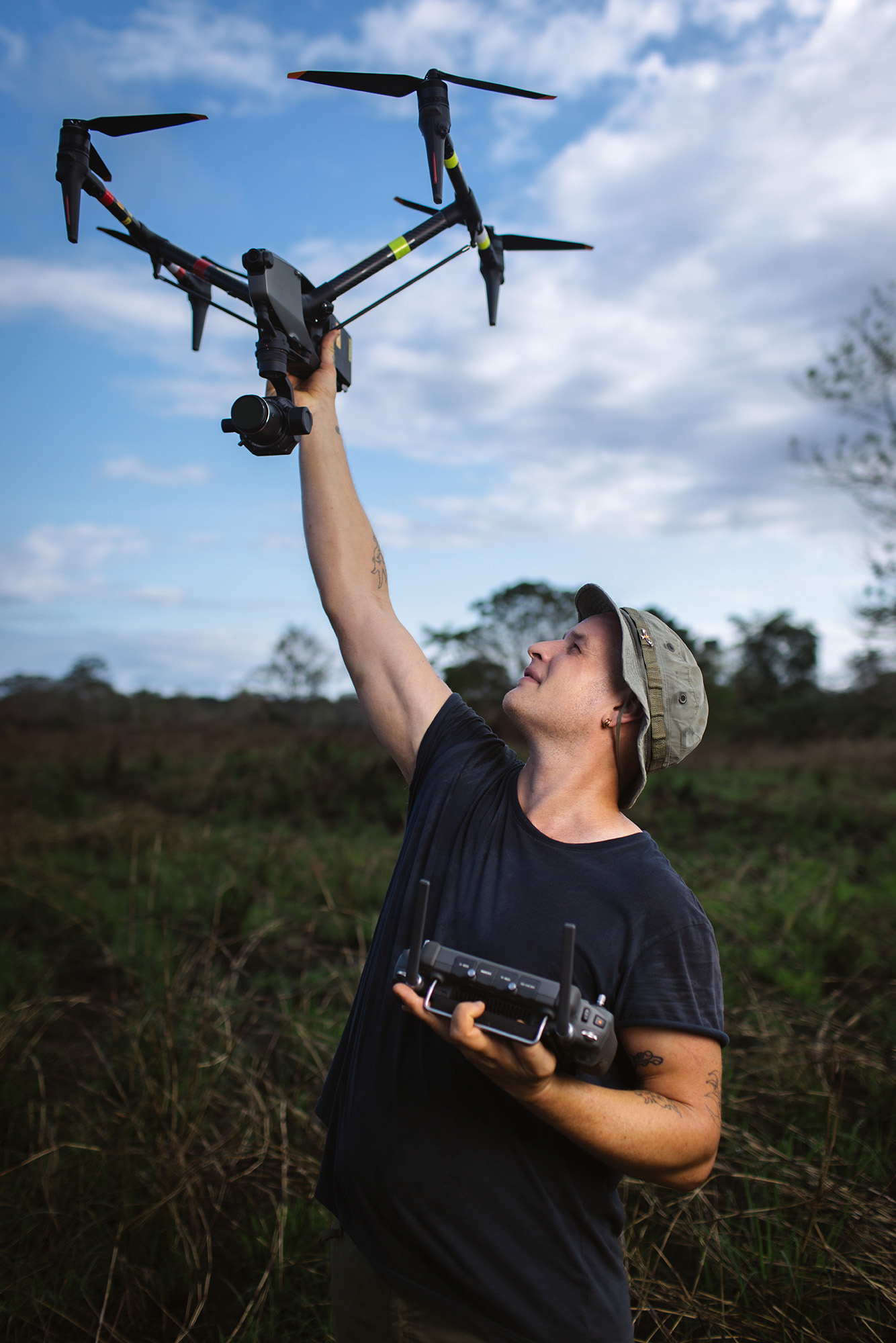 The Wild Ones presenter Declan Burley holding a drone up to the sky