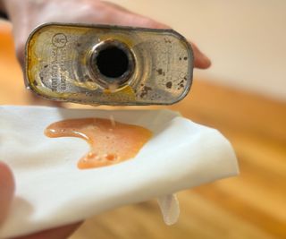 pouring worktop oil onto white lint-free cloth