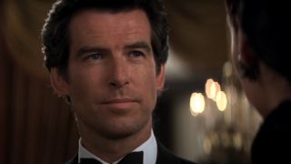 Pierce Brosnan smiling slightly at the casino in Goldeneye.