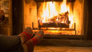 A person sitting by a roaring fire