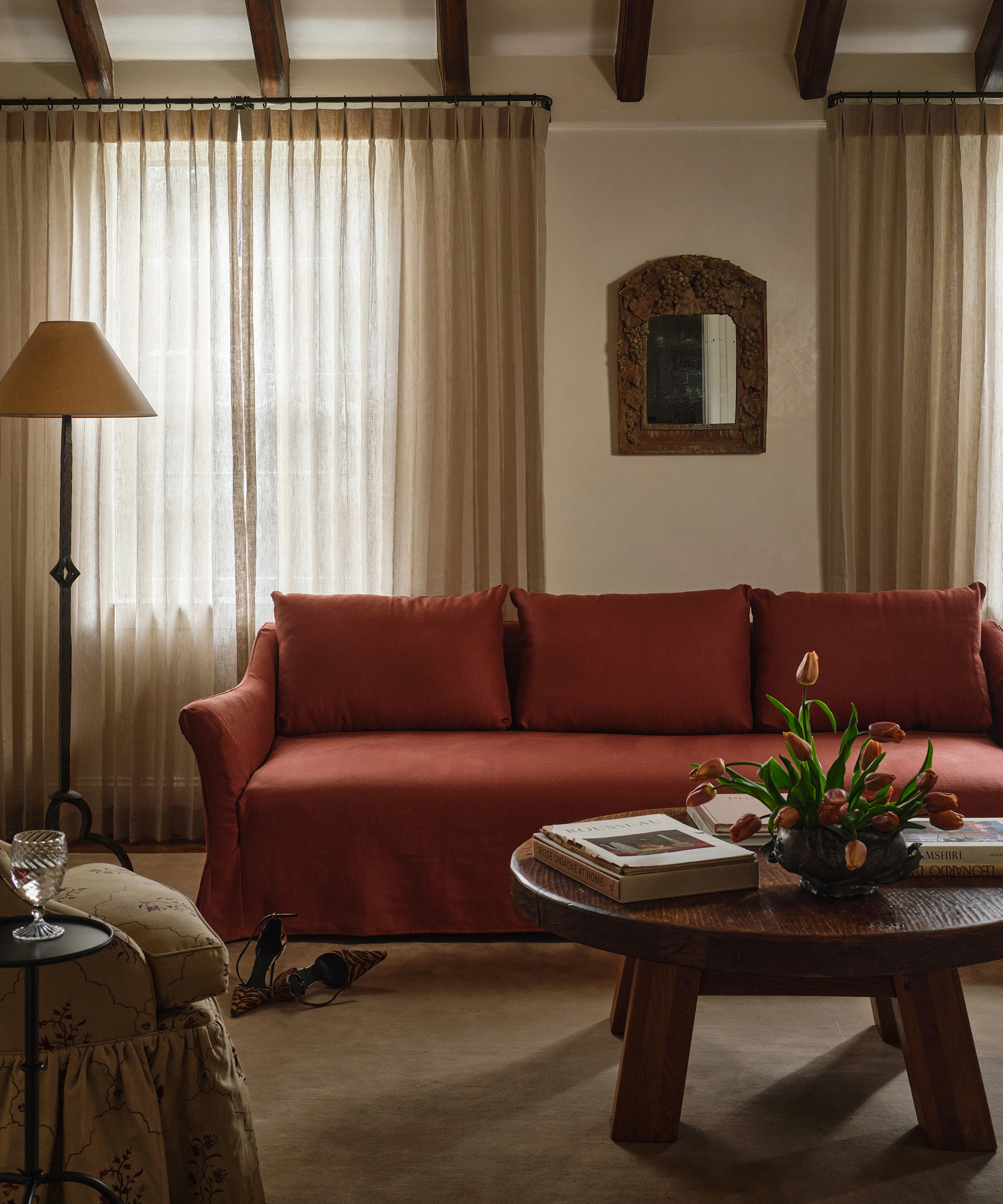 living room with red sofa and tulips on the coffee table