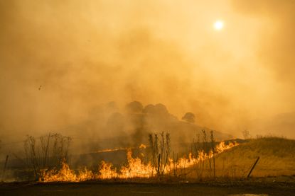 Flames and smoke from wildfires cover the landscape in California, U.S.