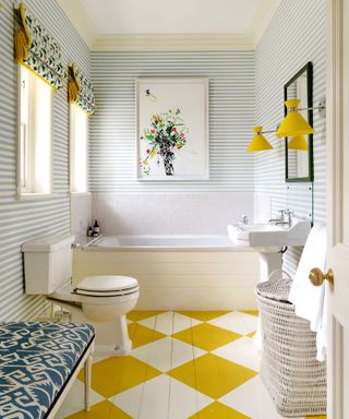 bathroom with yellow highlights including wall lighting, bathroom flow and blind edges