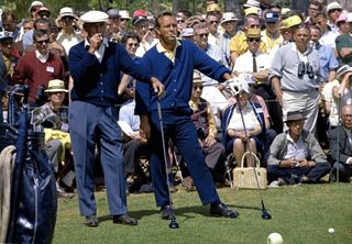 Ben Hogan and Arnold Palmer smoking while waiting on a tee GettyImages-82746243