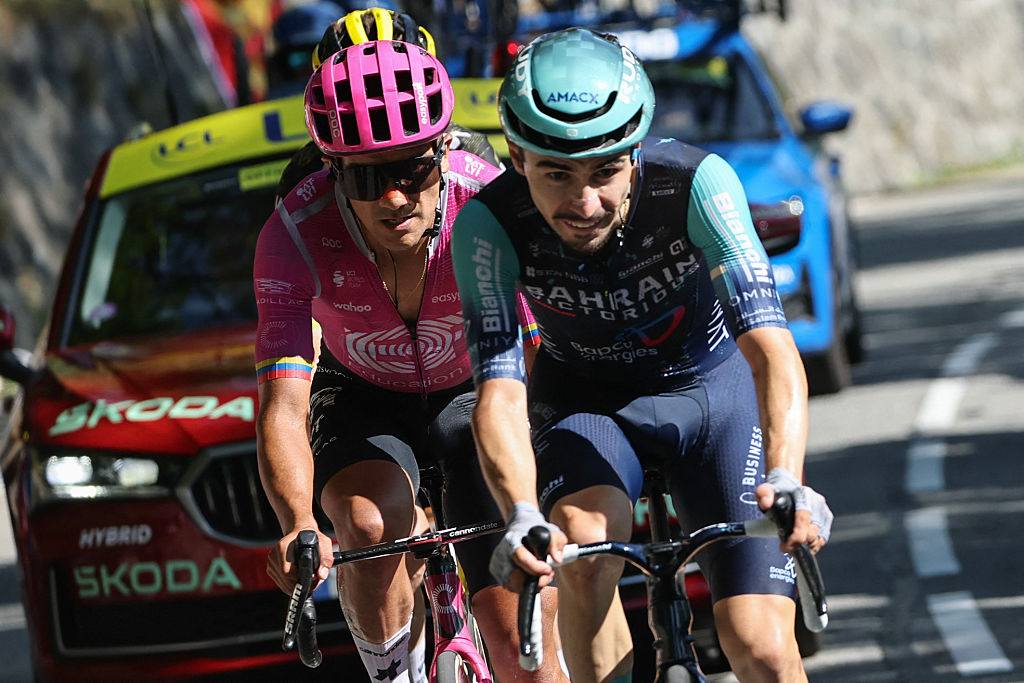 Bahrain - Victorious team's French rider Lenny Martinez (R) and EF Education - EasyPost team's Ecuadorian rider Richard Carapaz cycle in the lead breakaway in the Alpe d'Huez ascent during the 19th stage of the 113th edition of the Tour de France cycling race, 127,9 km between Gap and Alpe d'Huez in the French Alps, on July 24, 2026. (Photo by Anne-Christine POUJOULAT / AFP)