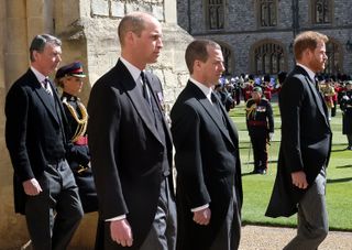 Vice-Admiral Sir Timothy Laurence, Prince William, Duke of Cambridge, Peter Phillips, Prince Harry, Duke of Sussex follow Prince Philip, Duke of Edinburgh's coffin during the Ceremonial Procession during the funeral of Prince Philip, Duke of Edinburgh at Windsor Castle on April 17, 2021 in Windsor, England