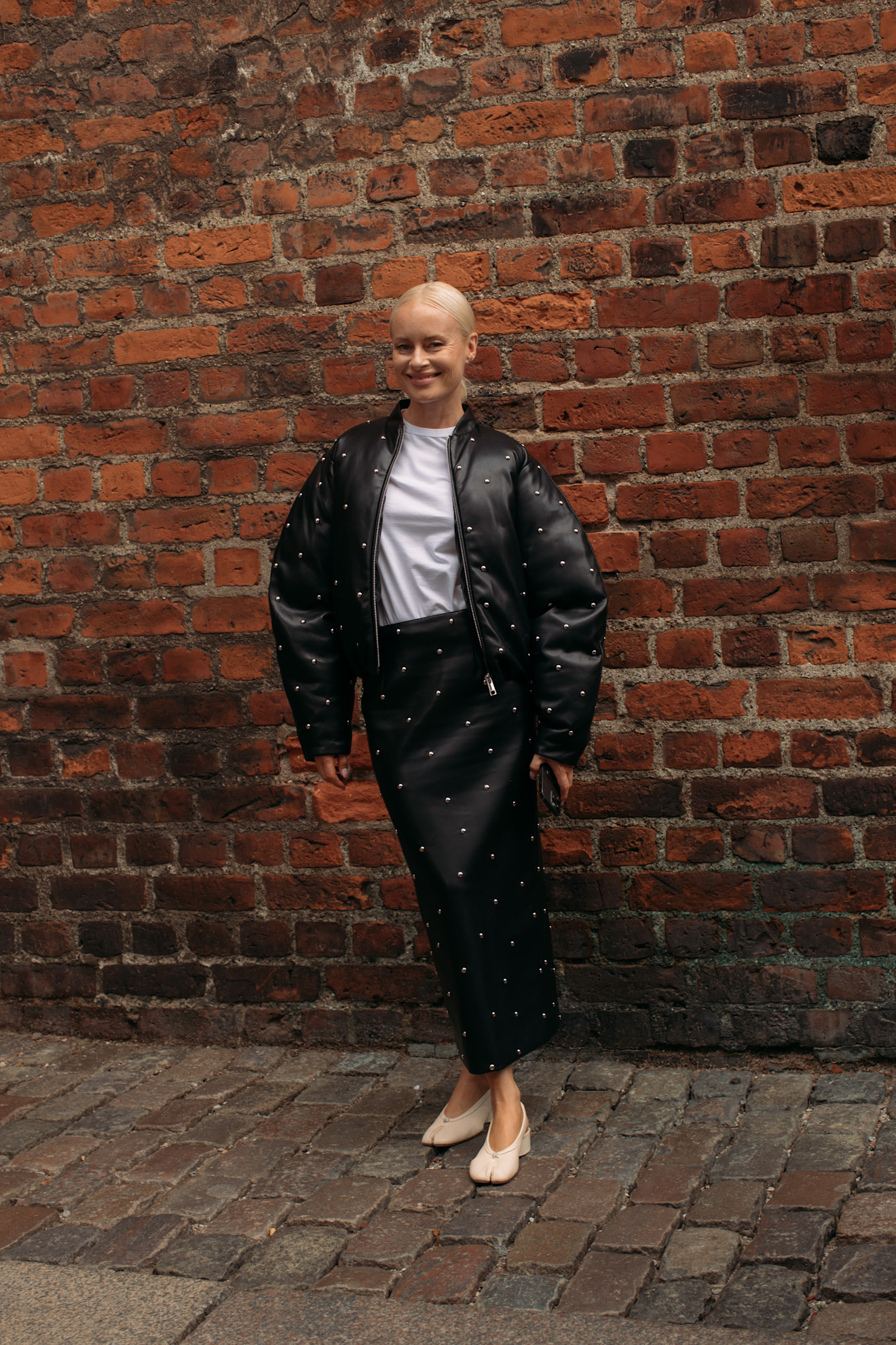 Woma wearing a black bomber jacket in Copenahgen