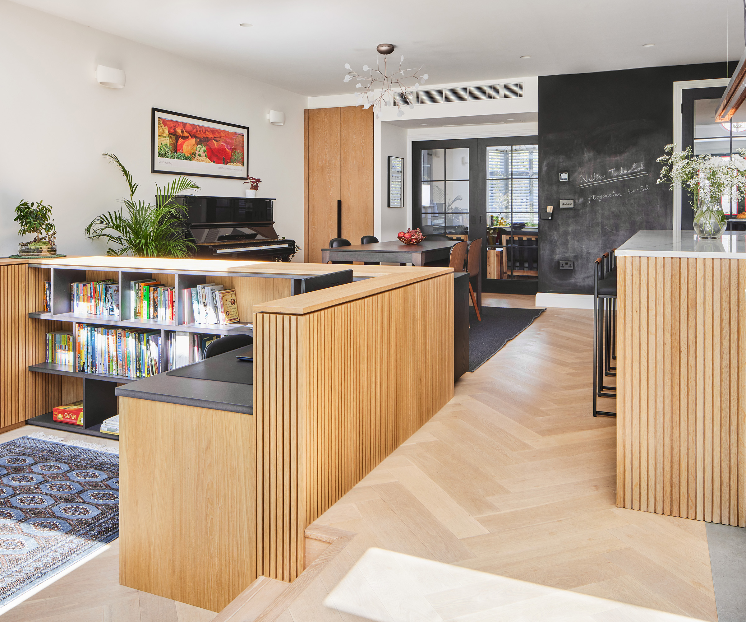 a study nook for children in an open plan kitchen and dining room