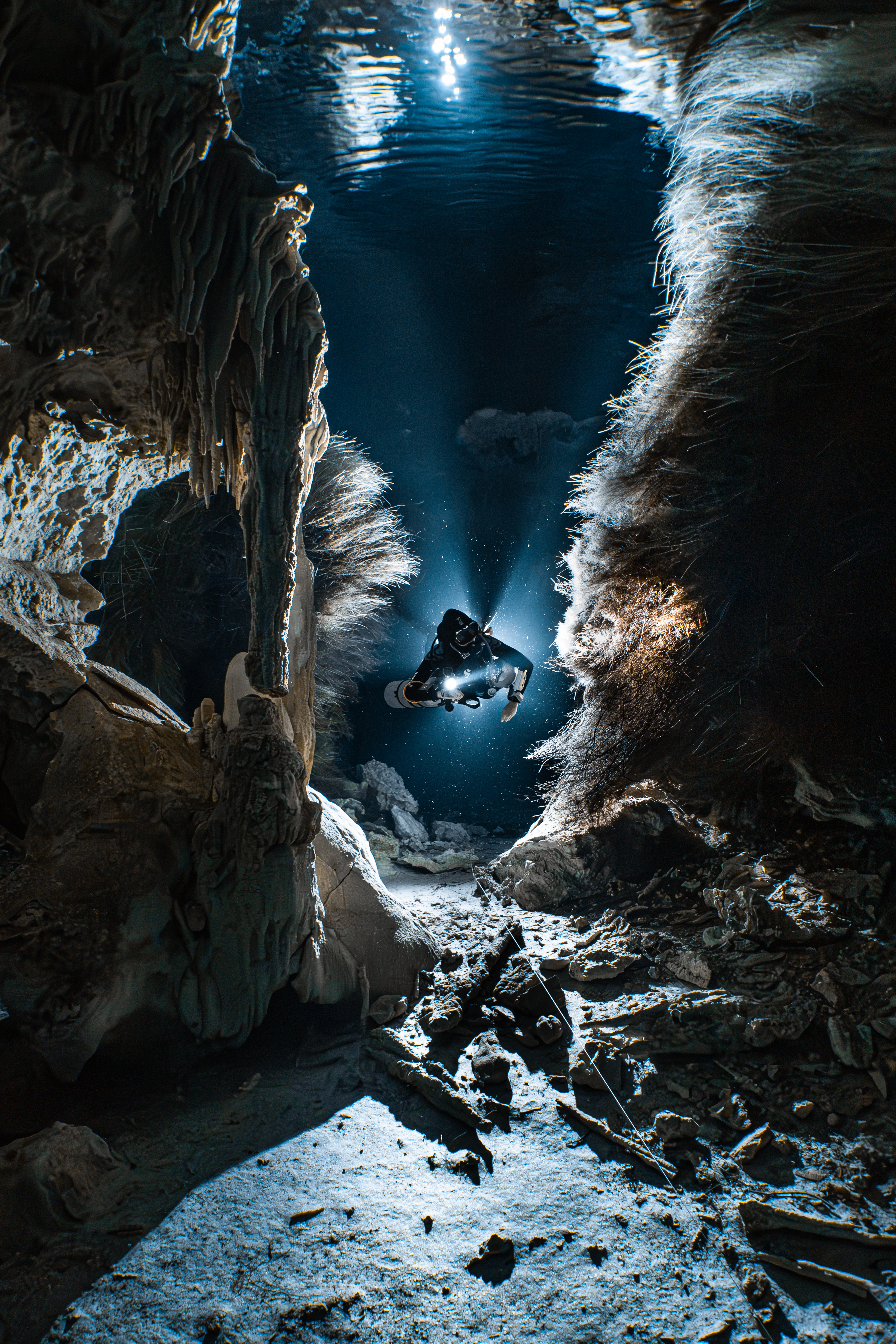 A diver moves through a cenote
