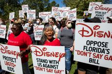 Protesters gather and hold signs urging Disney to protest Florida's 'Don't Say Gay' bill