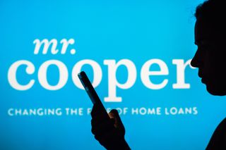 Mr Cooper logo seen in the background of a silhouetted woman holding a mobile phone