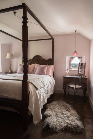 four-poster bed in renovated rustic cottage