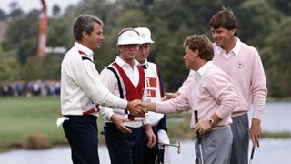 Ian Woosnam and Nick Faldo shake hands with Curtis Strange and Tom Kite after halving their opening foursomes match at the 1989 Ryder Cup