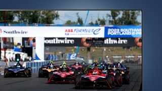 Some racing cars on the grid on a TV screen