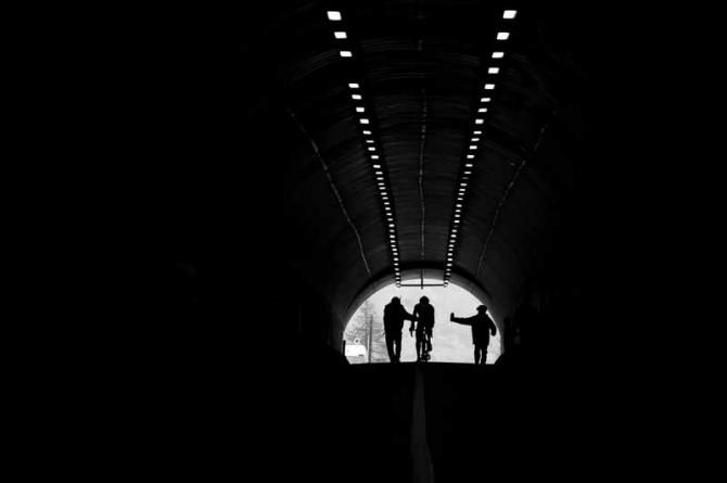 A lone rider gets assistance from tifosi in a tunnel during the Giro