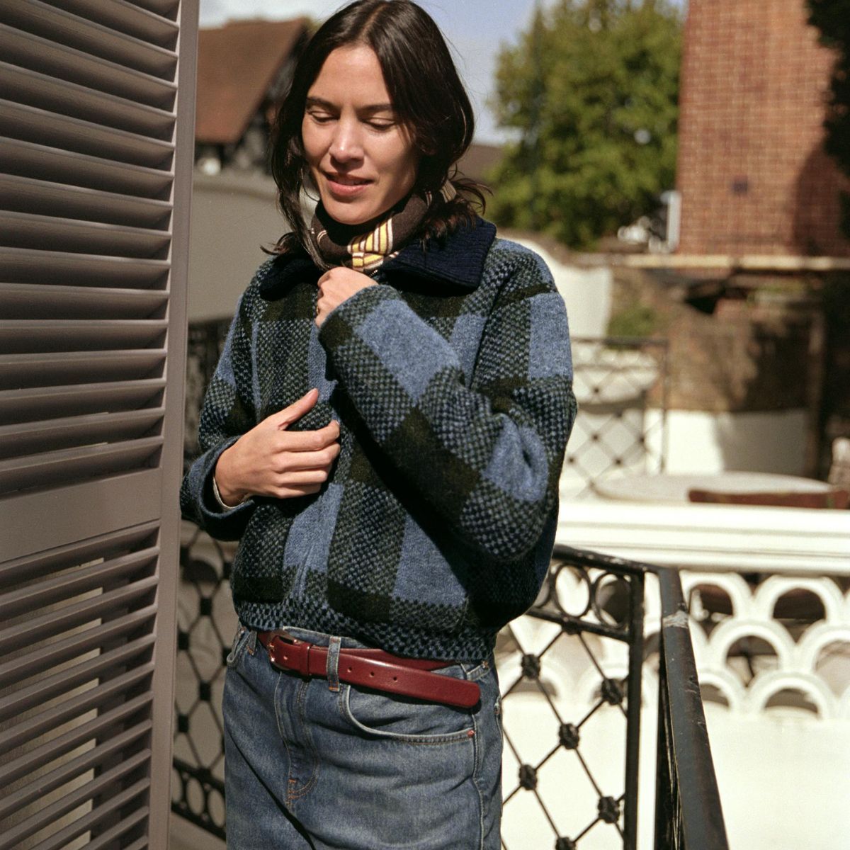 Alexa Chung wearing Zara's new collection. She's wearing a checked jacket and blue jeans.