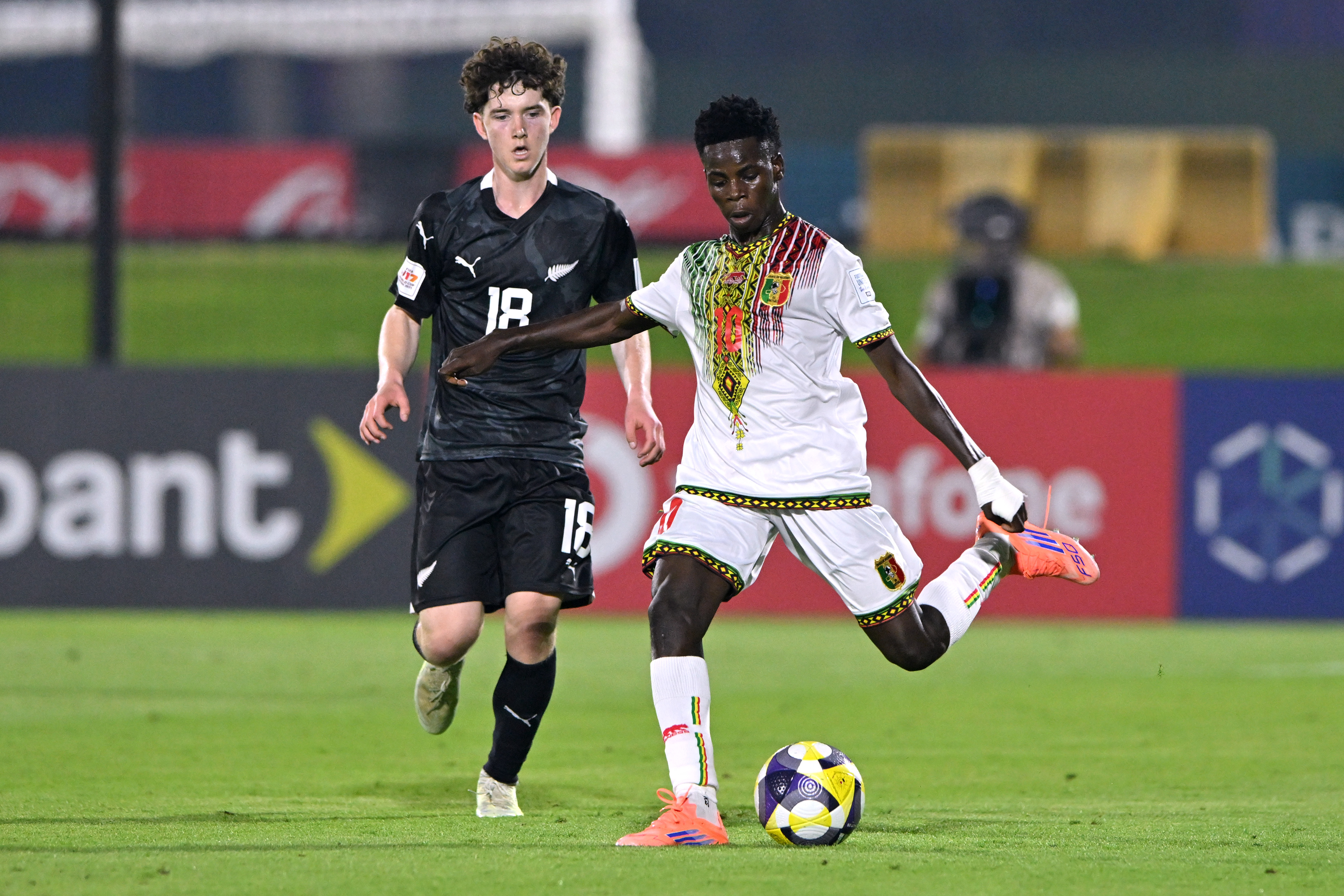 Seydou Dembele of Mali being followed by Daniel Nelson of New Zealand during the FIFA Under-17 World Cup match between Mali and New Zealand at Aspire Academy on November 05, 2025 in Doha, Qatar.