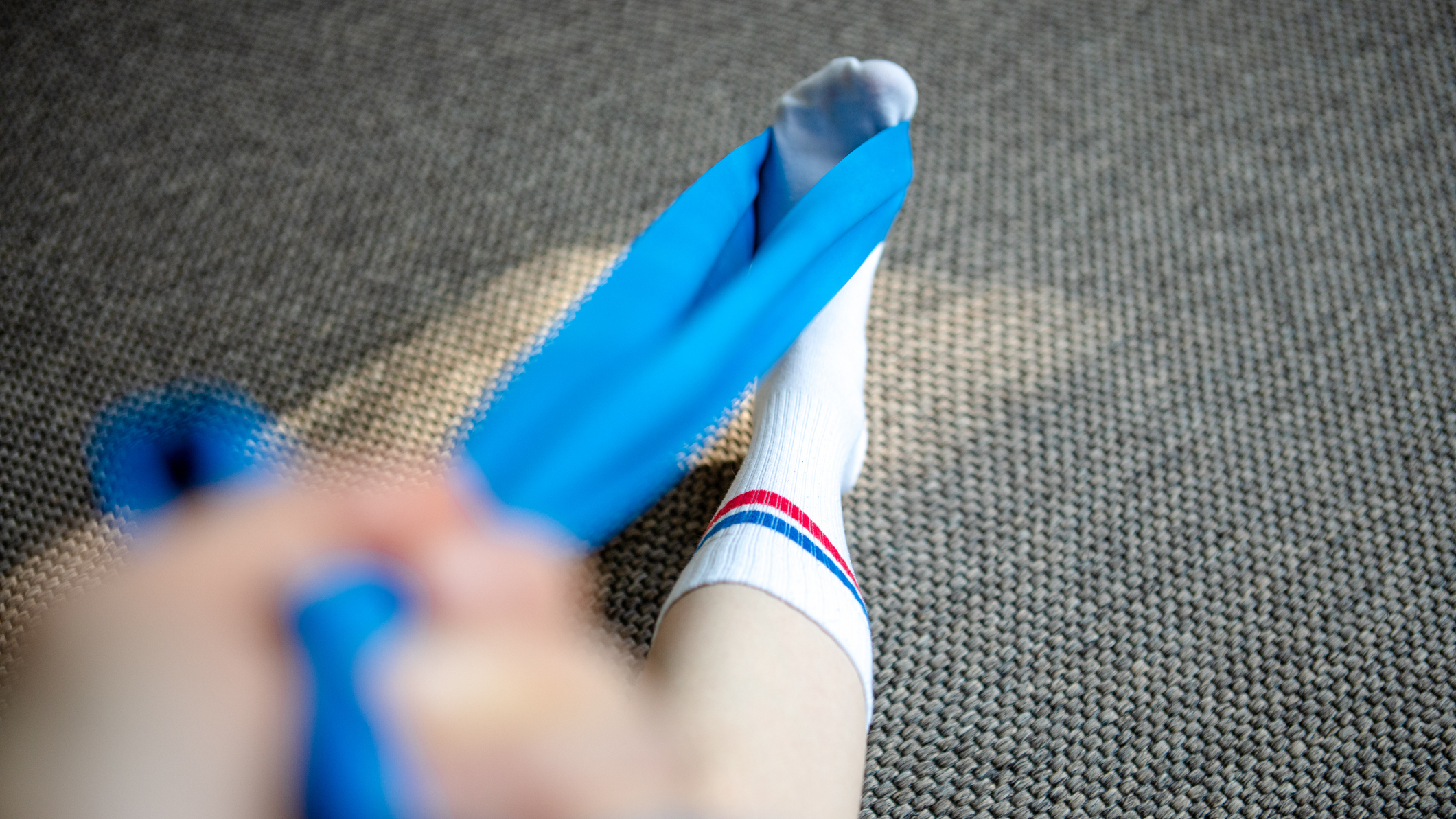 Resistance band wrapped around a foot