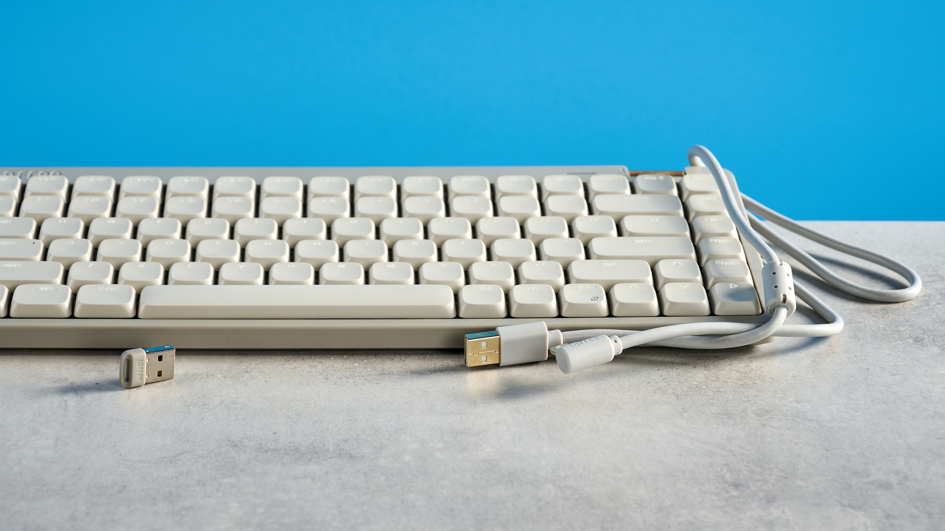 The Lofree Flow Lite84 on a stone surface against a blue background