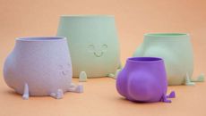 Playful, smiling plant pots in cute modern pastels