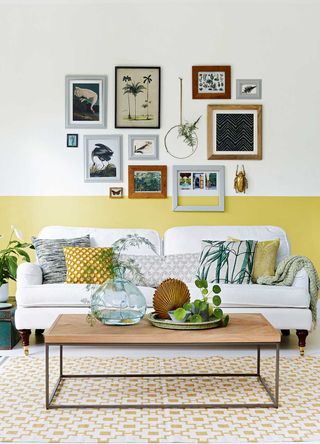 Living room with two tone walls of off-white and pale yellow on the lower third behind the sofa showing how to make a room look bigger with paint effects