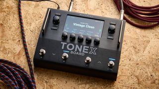 IK Multimedia Tonex Board shot on OSB wood surface.