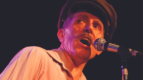 Wild Billy Childish singing into a microphone.