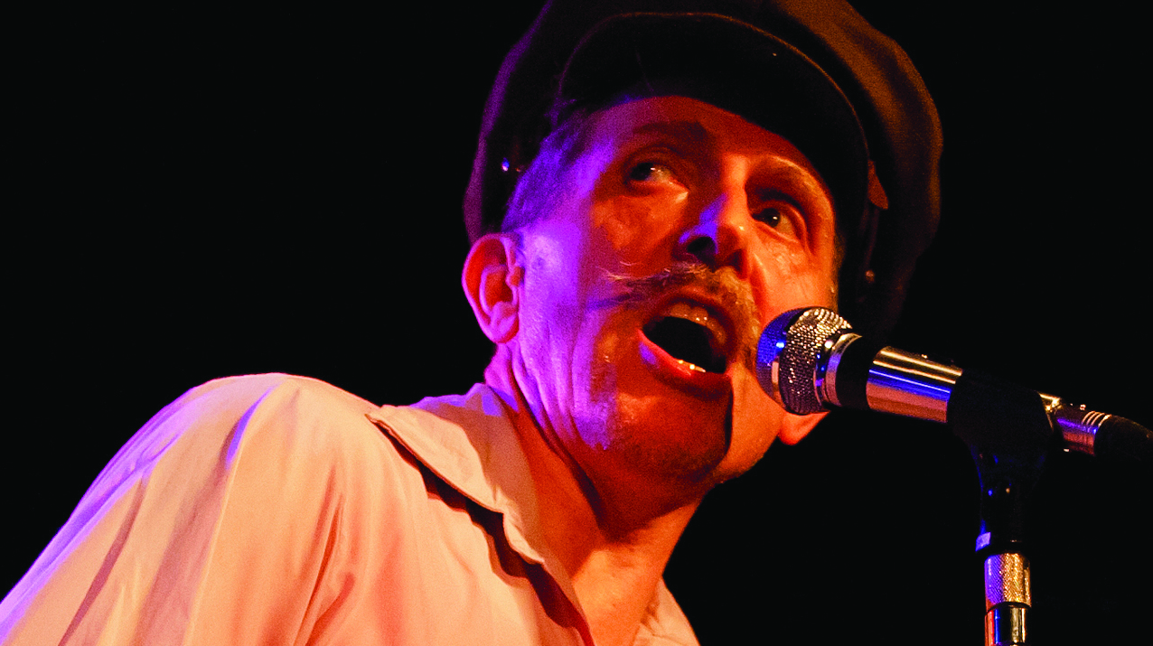 Wild Billy Childish singing into a microphone.