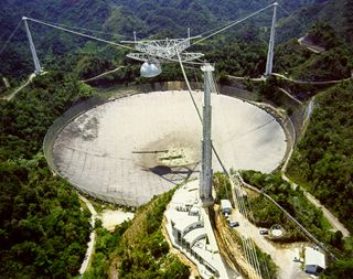 Some researchers want to use big radio dishes like the 305-meter Arecibo Observatory in Puerto Rico to announce our presence to intelligent aliens.