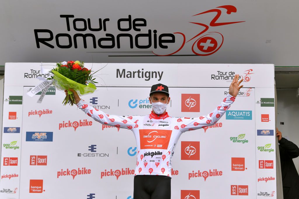 MARTIGNY SWITZERLAND APRIL 28 Joel Suter of Switzerland and Team Switzerland Polka Dot Mountain Jersey celebrates at podium during the 74th Tour De Romandie 2021 Stage 1 a 1681km stage from Aigle to Martigny Mask Covid safety measures Flowers TDR2021 TDRnonstop UCIworldtour on April 28 2021 in Martigny Switzerland Photo by Luc ClaessenGetty Images
