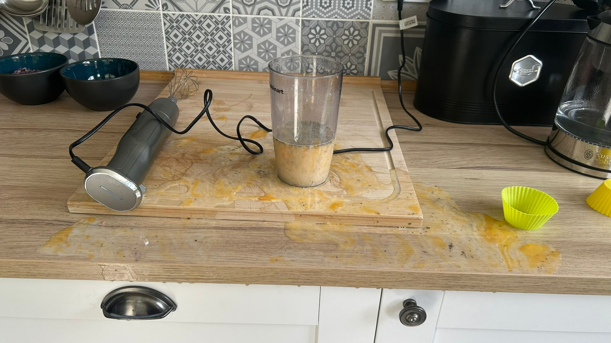 Cuisinart Power Blend Immersion Blender with splattered eggs on kitchen counter