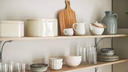An image of wooden shelves with crockery on them