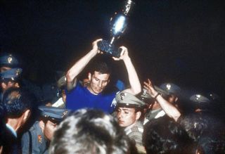 Italy captain Giacinto Facchetti lifts the European Championship trophy after victory over Yugoslavia in 1968.