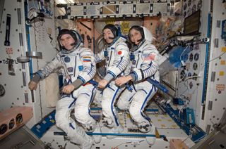 On the International Space Station's Unity node, NASA astronaut Sunita Williams, Expedition 33 commander; along with Japan Aerospace Exploration Agency astronaut Aki Hoshide (center) and Russian cosmonaut Yuri Malenchenko (left), both flight engineers, attired in their Russian Sokol launch and entry suits, take a moment for a photo as they prepare to perform the standard leak check in their spacecraft in preparation for their return to Earth on Nov. 18, 2012.