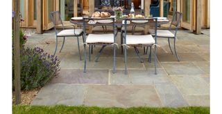 garden patio with dining table to support a step-by-step guide on how to clean patio slabs