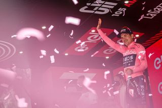 Overall leader Team Ineos Ecuadorian rider Richard Carapaz celebrates on the podium after the 15th stage of the Giro dItalia 2022 cycling race 177 kilometers from Rivarolo Canavese Piedmont to Cogne Aosta Valley on May 22 2022 Photo by Luca Bettini AFP Photo by LUCA BETTINIAFP via Getty Images