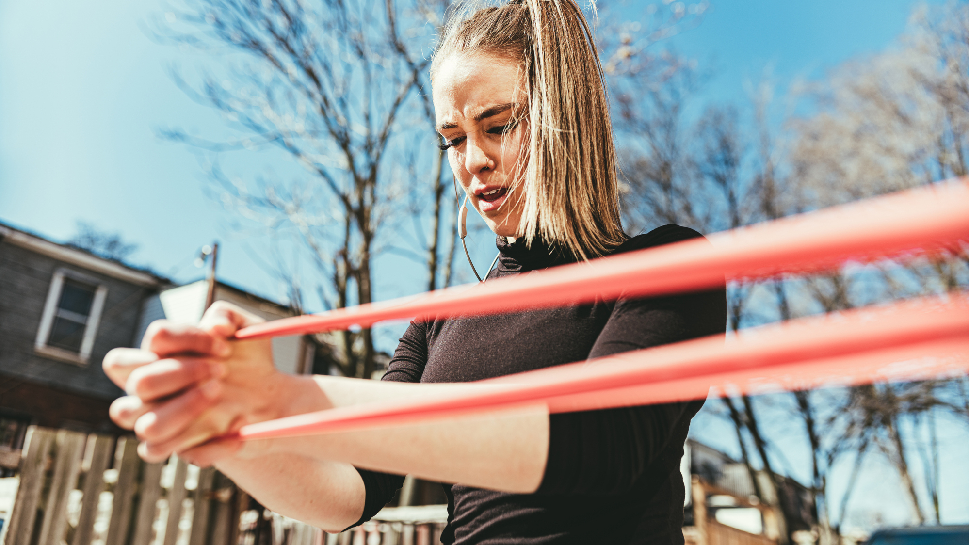 Woman exercising with resistance band outside
