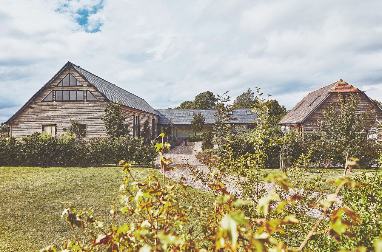 house exterior and driveway and wooden walls and garden 