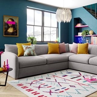 living room with indigo blue walls and sofa set with cushion