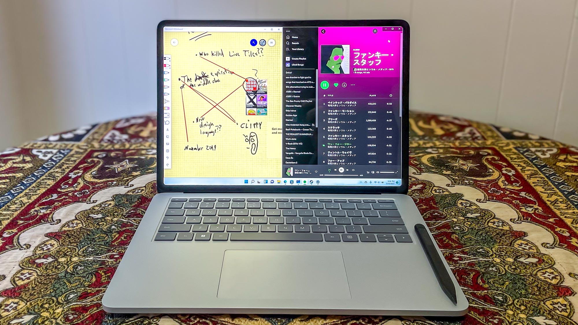 Microsoft Surface Laptop Studio open on table playing music