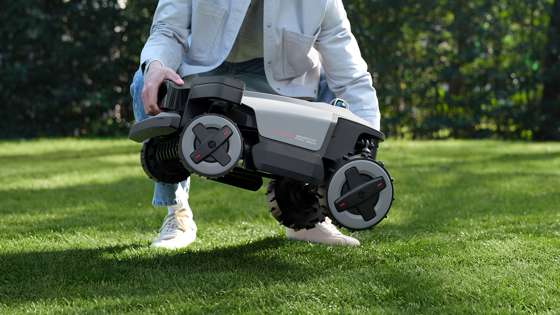 Roborock RockMow X1 LiDAR lawnbot being placed on the ground