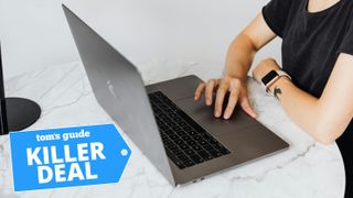 Woman on laptop with Tom's Guide logo