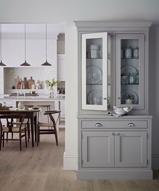 a stylish and modern neutral kitchen with gray dresser