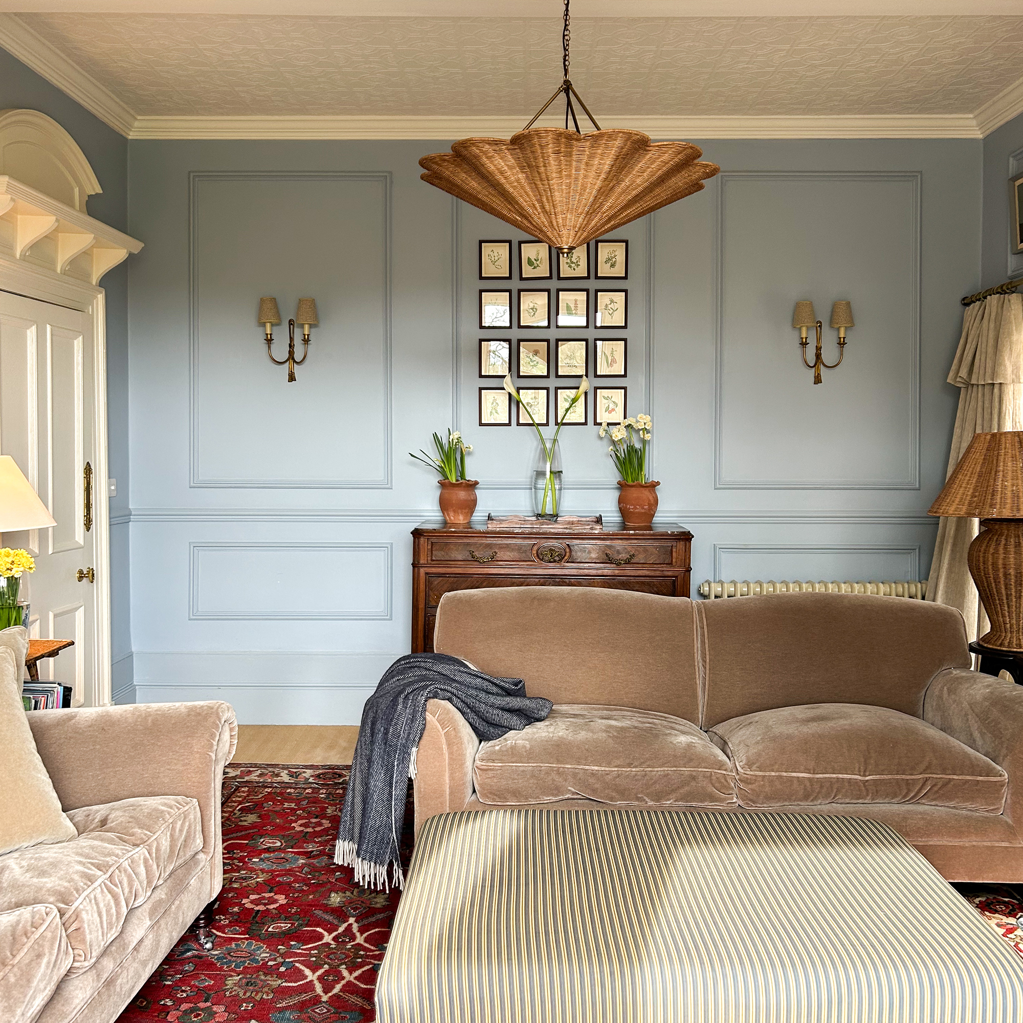 blue living room with rattan ceiling light