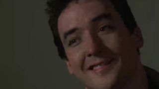 A close up of John Cusack smiling in Say Anything